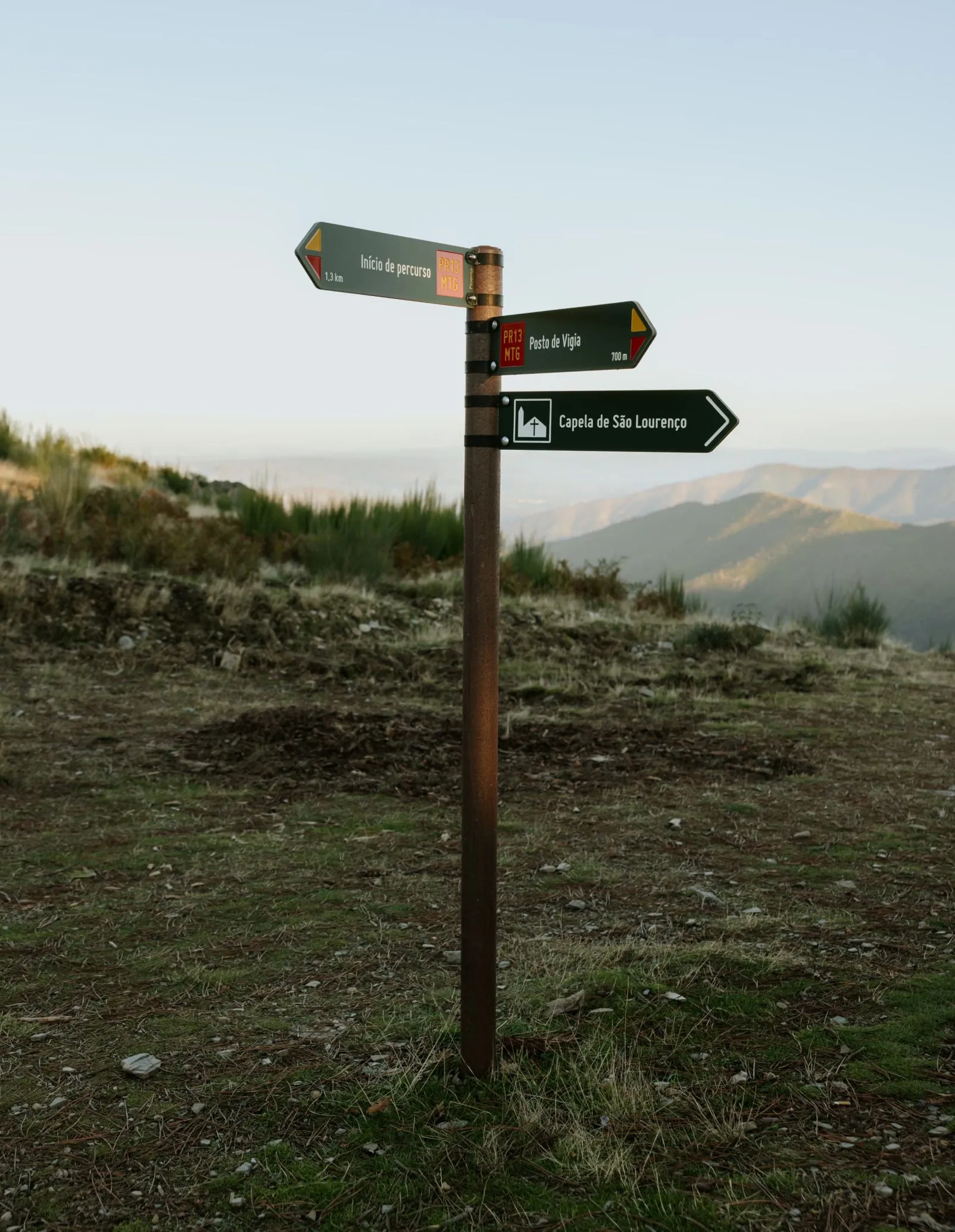 Placas direcionais para percursos pedestres em HPL+, modelo Floema, com sistema de fixação de abraçadeiras e poste em plástico reciclado castanho, em área natural protegida. 