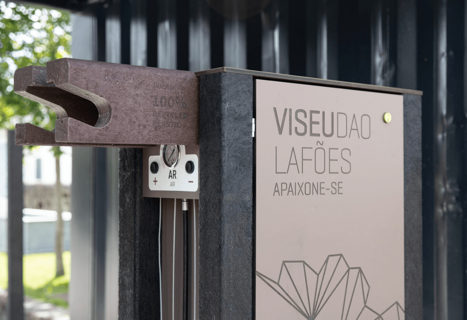 Detalle del soporte y de la bomba de aire de la bike station high tech Floema personalizada, con estructura en plástico reciclado negro y HPL+.