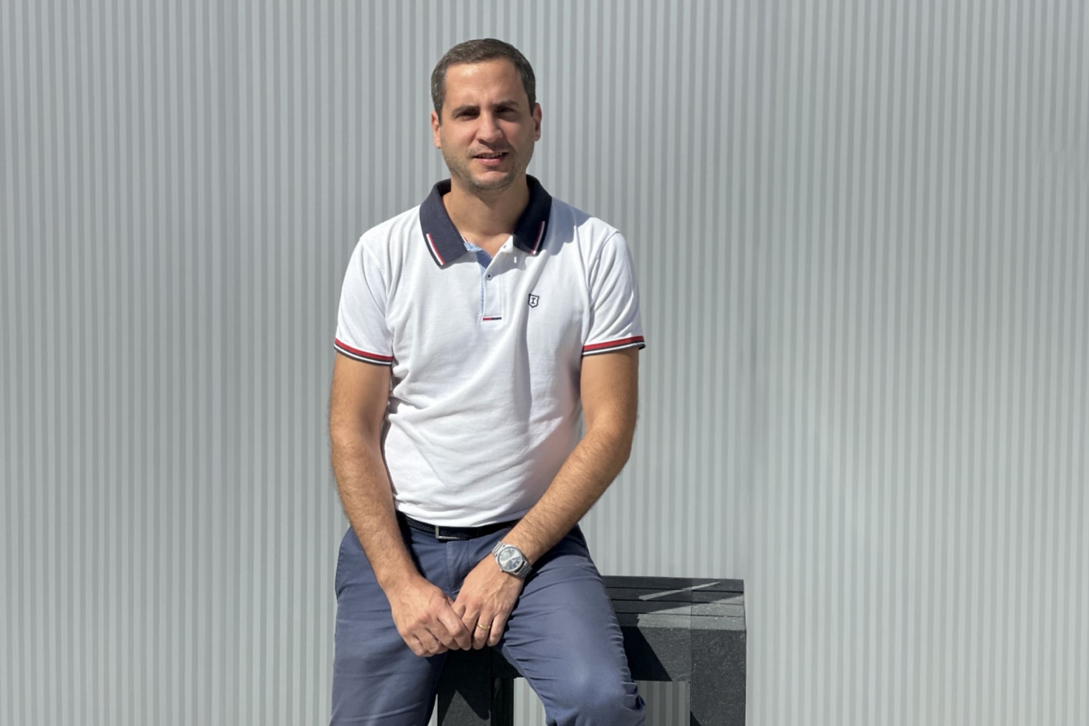 Floema® Chief Financial Officer Tiago Costa, seated on a Floema® recycled plastic bench