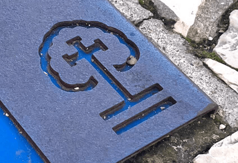 Detail of information engraved on pavement marking for religious routes, Fatima path in steel with coloured HPL plate, installed on pavement.